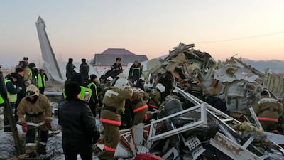 In this handout photo provided by the Emergency Situations Ministry of the Republic of Kazakhstan, police and rescuers work on the site of a plane crash near Almaty International Airport, outside Almaty, Kazakhstan. AP