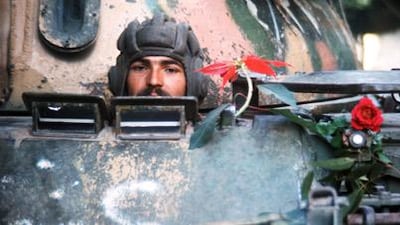 The Soviets and Americans were anxious to avoid direct conflict - but determined not to be defeated in proxy battles: A Syrian soldier peers from a Russian-made tank rolling into Beirut in 1976.