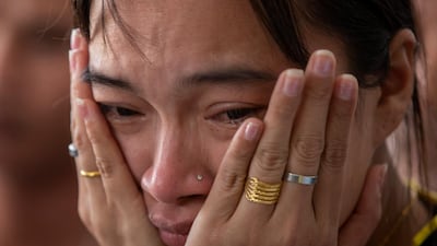 A relative of a missing person waits outside the emergency room where victims of the mass shooting are being treated in Korat, Nakhon Ratchasima, Thailand. AP Photo