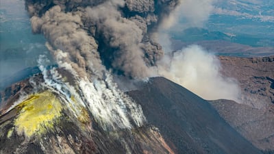 A plum of ashes rises from a crater of the Mount Etna volcano during an eruption. AFP