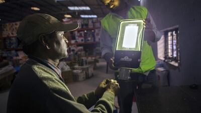 Employees check an Elecssol light-emitting diode (LED) street light at the refurbishment facility of GreenDust. Prashanth Vishwanathan / Bloomberg