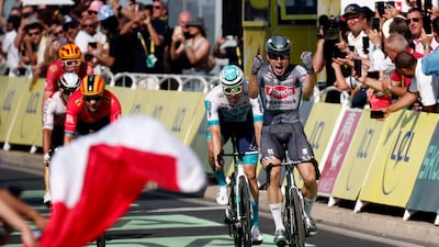 Alpecin-Deceuninck's Jasper Philipsen celebrates as he crosses the finish line. Reuters