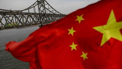 A Chinese flag in front of the Friendship bridge over the Yalu River connecting North Korea and China. Chinese commerce ministry says the US measures against China’s investments are against World Trade Organization rules. Reuters