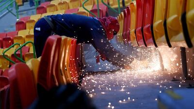 A Brazilian worker makes improvements on the stands of the Future Arena where the Olympic Handball competition will take place in Rio de Janeiro. Roberto Schmidt / AFP Photo