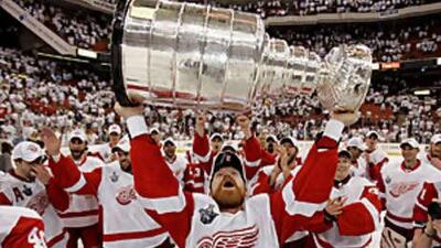 Detroit Red Wings centre Kris Draper holds up the Stanley Cup after the Red Wings defeated the Pittsburgh Penguins 3-2 in Game 6 to win the trophy in Pittsburgh.
