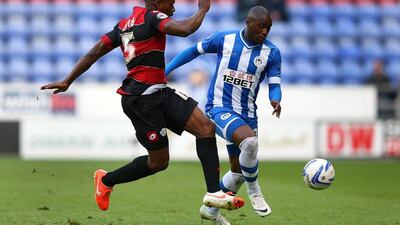 Marc-Antoine Fortune of Wigan Athletic takes on Nedum Onuoha of Queens Park Rangers during the Championship play-off semi-final first leg match at DW Stadium on Friday. Alex Livesey / Getty Images / May 9, 2014