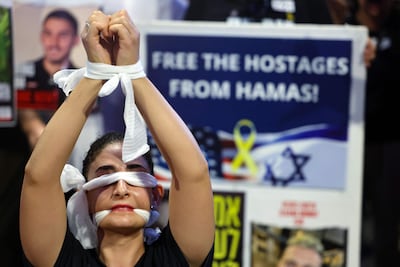 A demonstrator in Tel Aviv calls for action to secure the release of Israeli hostages held in Gaza. AFP