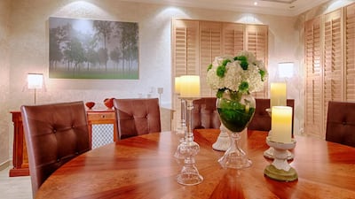 A custom-made mahogany table was inlaid with a contrast of veneers in a geometrical pattern, while the buffet cabinets had metal grills in alternative geometrics. The backs of the leather chairs were stitched in a square pattern style, so every piece of furniture had an element of pattern, whilst the overall look is one of calm order. The artwork reflects nature and adds stillness to the area