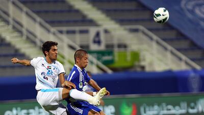 Bainyas' Mohamed Jaber and Takayuki Morimoto of Al Nasr battle it out. Satish Kumar / The National