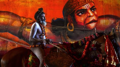 An Indian naked sadhu (Hindu holy man) rides a horse as he takes part in a religious procession towards the Sangam area during the 'royal entry' for the upcoming Kumbh Mela festival in Allahabad. AFP