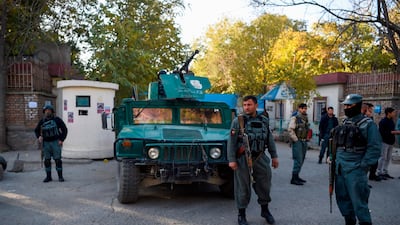 Policemen stand guard an entrance to Kabul university a day after gunmen stormed the campus on November 2, 2020. AFP