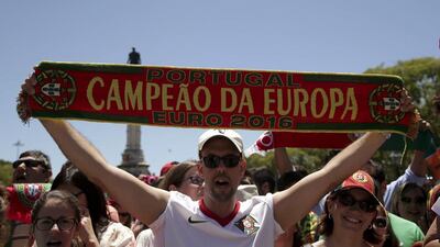 Portugal national soccer team supporter holds a scarf with the words ‘Portugal European Champion Euro 2016’ in front of the Belem palace in Lisbon, Portugal, 11 July 2016. The Portugal national soccer team on 10 July 2016 had won the UEFA Euro 2016 final against France by 1-0 to win the title for first time. EPA/ANTONIO COTRIM