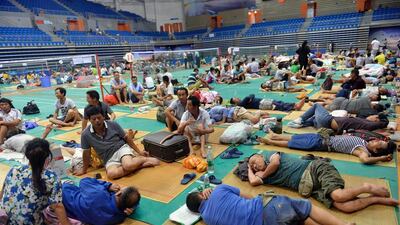 Chinese workers rest at Nansha Stadium as Typhoon Nida hit the area in Guangzhou, south China’s Guangdong province. Typhoon Nida made landfall in southern China on Tuesday as hundreds of flights were cancelled as the storm brought violent winds and torrential rain. AFP / STR