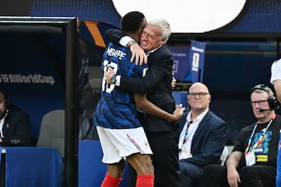 Kylian Mbappe celebrates with bereaved coach Didier Deschamps after scoring against Sweden. AFP