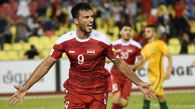 Syria's Omar Al Somah, left, scored a contentious goal against Australia on Thursday night. Mohd Rasfan / AFP