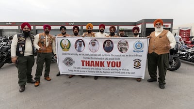 Singh's UAE MC members hold a banner thanking the UAE