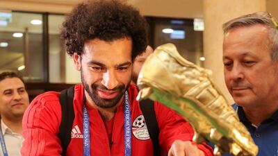 Mohamed Salah receives a cake, weighing 100 kilograms and decorated with a golden football boot, as a present on his birthday in Grozny. Alkhazur Kerimov / Reuters