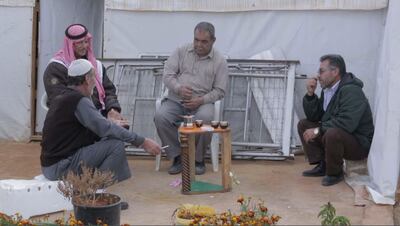 Men talk over coffee in ‘Men on Hold’. Courtesy Forward Film Productions / Muna Khalidi