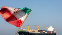 Ships wait near Iran's Larak Island, in the Strait of Hormuz, amid efforts to force Tehran to reopen the waterway. Getty Images