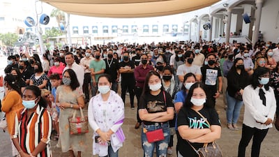 Worshippers listen to speakers and watch the service on big screens outside St Mary's Catholic Church in Dubai. Pawan Singh / The National