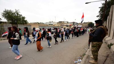An Iraqi soldier stands guard as Iraqi university students take part in a strike and protests in central Baghdad. EPA
