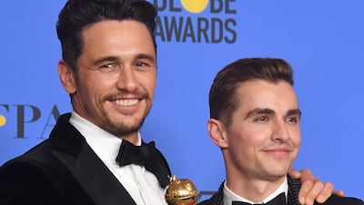 Dave Francoposes with James Franco and his trophy for Best Performance by an Actor in a Motion Picture - Musical or Comedy during the 75th Golden Globe Awards on January 7, 2018, in Beverly Hills, California AFP