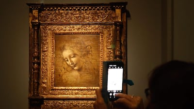 An oil on wood painting by Leonardo da Vinci's " The Head of a Woman—also known as La Scapigliata ", during the opening of the exhibition " Leonardo da Vinci at the Louvre museum in Paris. AFP