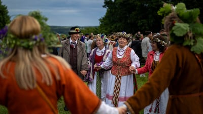 Dancers wearing traditional costumes celebrate Saint John's Day and the summer solstice in the small town of Kernave, Lithuania. AP