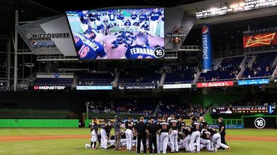 Miami Marlins players gather around the mound following their win over the New York Mets. Rob Foldy/Getty Images