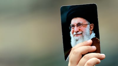 A Hezbollah supporter carries a portrait of the late Iranian supreme leader Ayatollah Ali Khamenei during a demonstration in Beirut on Sunday. EPA
