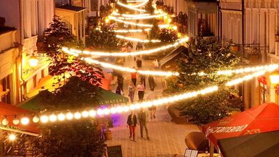 People walk past open restaurants along a pedestrian street in central Tbilisi, Georgia as the country tries to curb the spread of the coronavirus. Cafes and restaurants re-opened in Georgia's capital last week. AFP