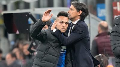Inter Milan managerh Simone Inzaghi hugs Lautaro Martinez. AP