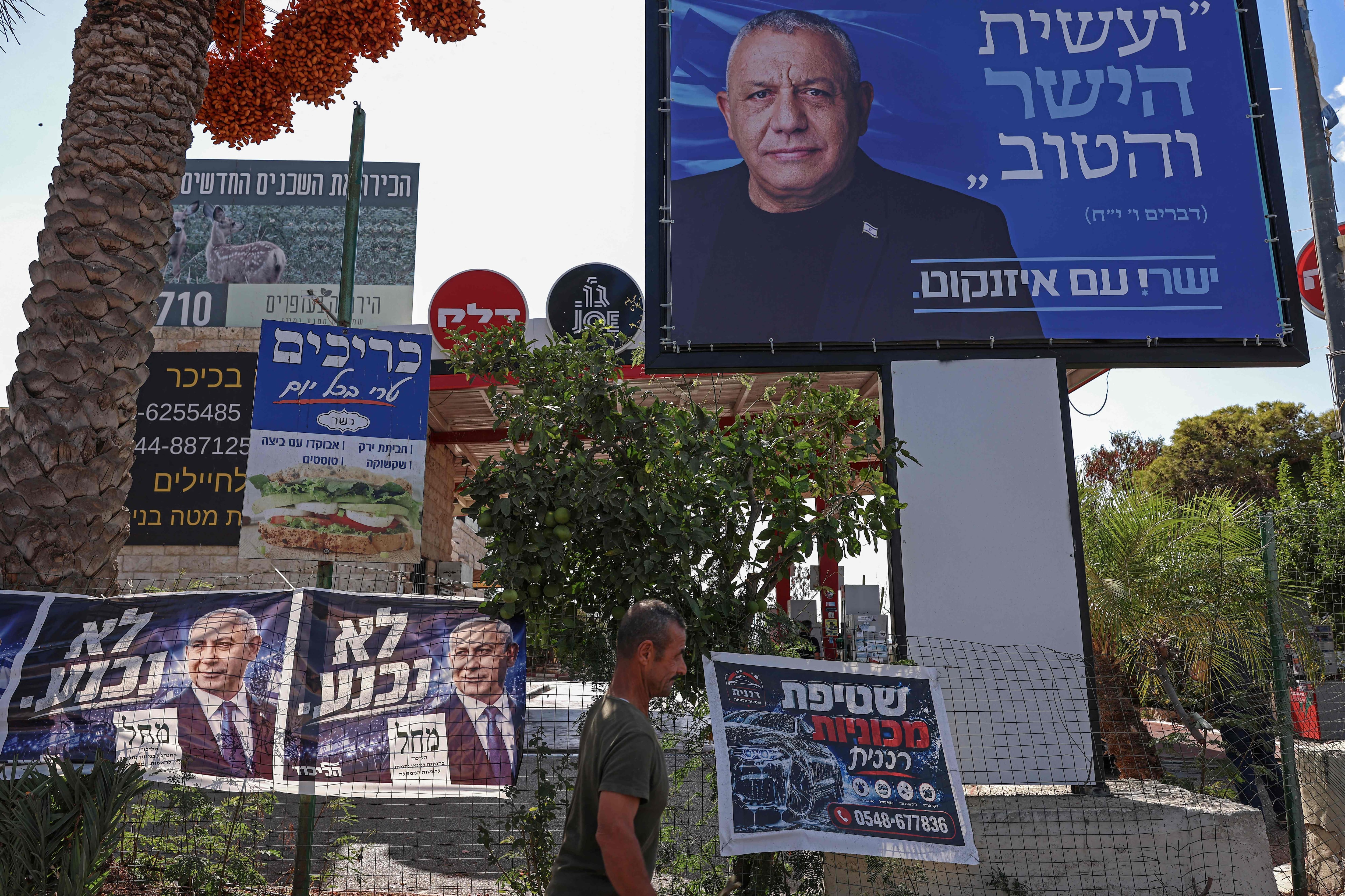 Posters and banners featuring Israeli Prime Minister Benjamin Netanyahu, left, and election rival Gadi Eisenkot, in Ramallah. AFP