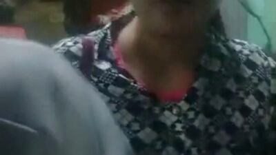 A woman leaves her house while being escorted by soldiers (unseen) at an unidentified location in Myanmar, in this picture obtained from social media. Reuters