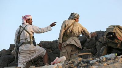 A militant and a soldier loyal to Yemen's exiled government stand in an area where they are fighting against the Houthi militia in Yemen's central province of Marib September 14, 2015. Reuters