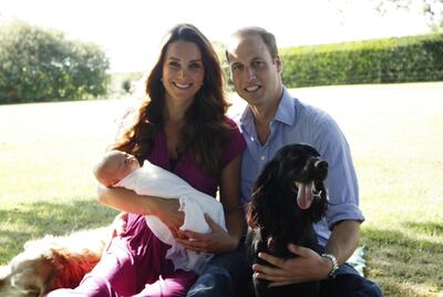 The Duke and Duchess of Cambridge with a newborn Prince George and Lupo their pet dog in October 2013. AFP