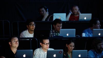 Writers use computers during the Sony news conference show. David McNew / Reuters