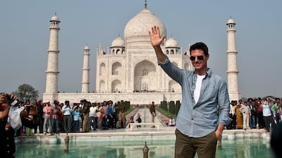 US Hollywood actor Tom Cruise waves as he poses at the Taj Mahal on December 3, 2011. AFP