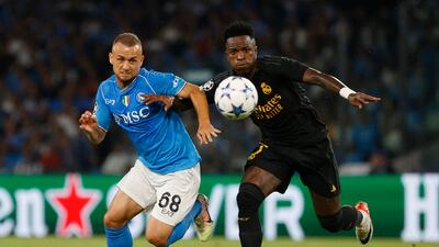 Napoli's Stanislav Lobotka vies for the ball with Real Madrid's Vinicius Junior. Reuters