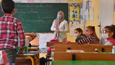 Students sit in a classroom while wearing face masks due to the COVID-19 pandemic on the first day of school following the resumption of classes in the Algerian capital Algiers. AFP