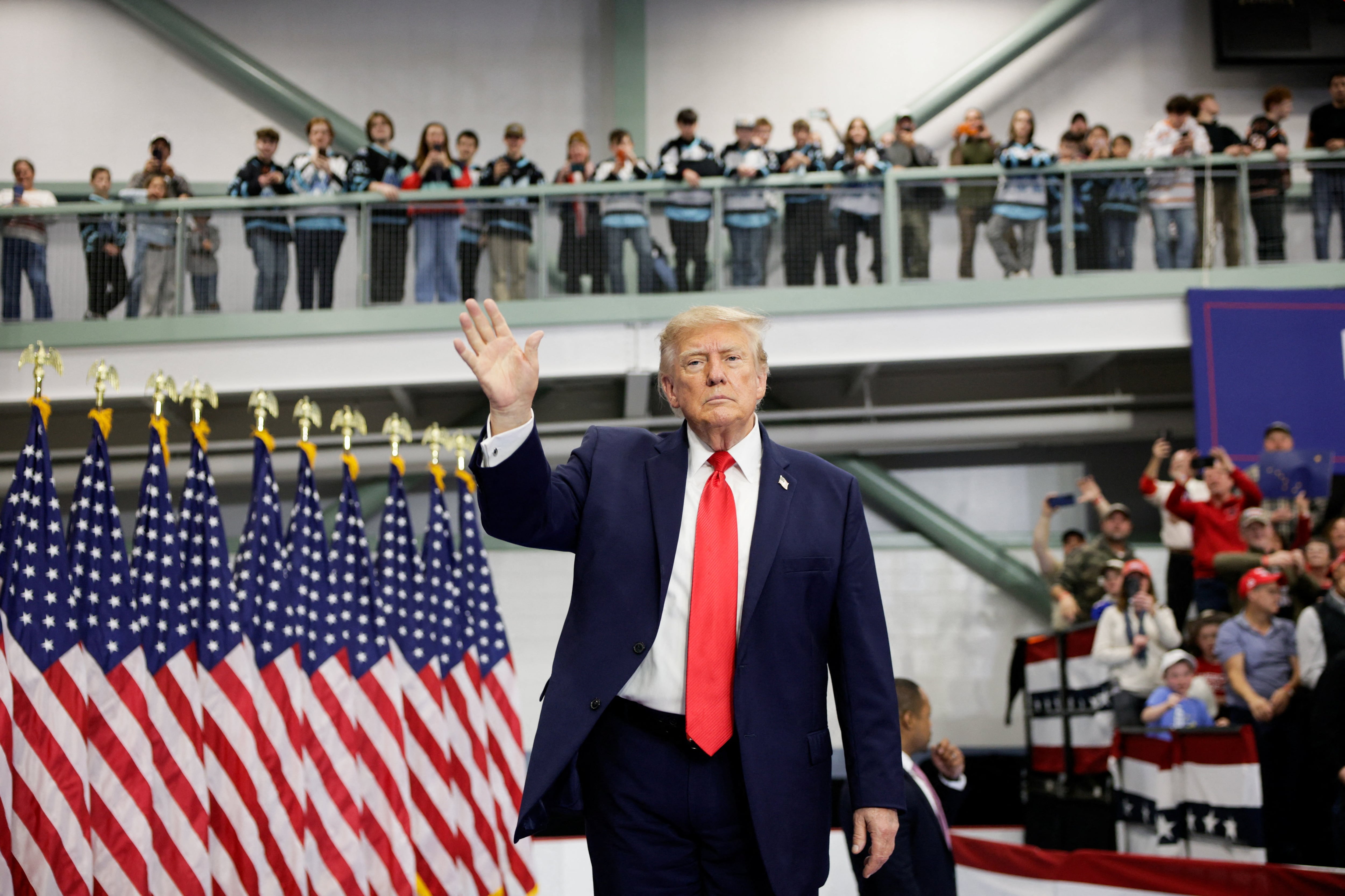 US President Donald Trump waves on stage at the Curtis D. Menard Memorial Sports Centre in Wasilla, Alaska. Reuters
