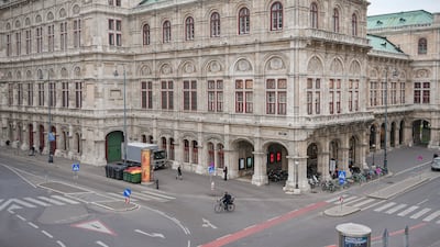 A cyclist rides along an almost deserted street in Vienna, the Austrian capital. Austria began a nationwide lockdown on Monday to address soaring numbers of coronavirus infections. AP