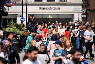 People walk through Covent Garden in central London on June 3. The UK government are set to decide on June 14 whether their plan to completely lift coronavirus restrictions will go ahead as scheduled on June 21 amid concern over rising infections. AFP