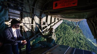 Gazing out from the helicopter. AFP