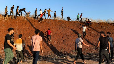 Syrian demonstrators throw stones during clashes near the Turkish army observation point in Ibbin Samaan. AFP