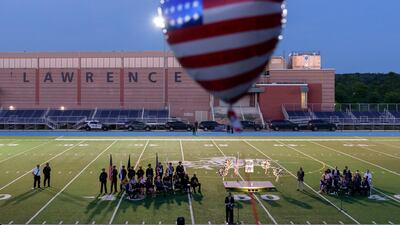 Loved ones and guests attend a vigil at Veterans Memorial Stadium in Lawrence, Massachusetts, for Sgt Johanny Rosario Pichardo, a US Marine who was among 13 service members killed in a suicide bombing in Afghanistan. AP Photo