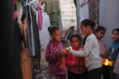Young displaced Palestinians play with Ramadan lanterns in the Bureij refugee camp in central Gaza. AFP