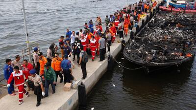 Security forces, Red Cross and rescue workers carry body bags with the remains of victims after a fire ripped through a boat carrying tourists to islands north of the capital, at Muara Angke port in Jakarta, Indonesia. Darren Whiteside / Reuters