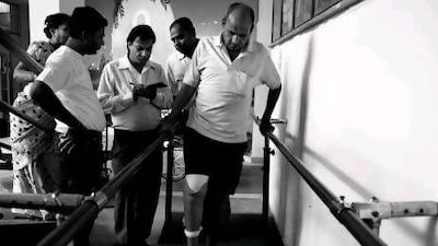 As his relatives watch, ML Kabra takes his first steps since losing his leg to diabetes last year.