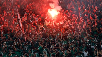 Al Ahli fans celebrate with flares inside the stadium after the match. Reuters